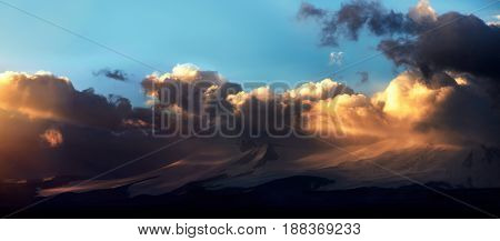Altai Ukok the sunset over the mountains in cloudy cold weather. Wild remote places no one around. Rain clouds over the mountains