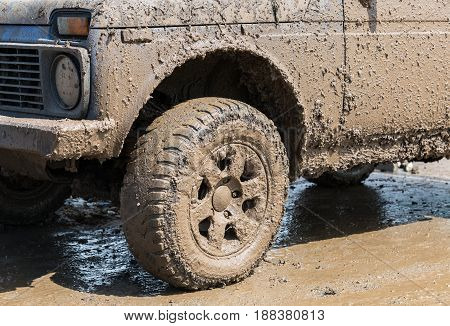 Dirty wheel of an off-road car after driving in the rain