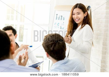 Asian businesswoman making a presentation in the meeting - female leader concept