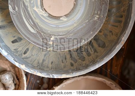 An empty circle, where the potter molds product. Creative studio potter. Workplace wizard Crock pottery. Top view