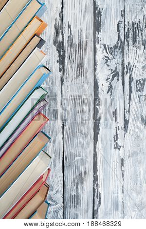 Stack of colorful books. Education background. Back to school. Book, hardback colorful books on wooden table. Education business concept. Copy space for text