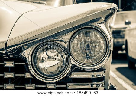 BERLIN GERMANY - MAY 17 2014: Headlamp of the Buick LeSabre (First generation). Stylization. Toning. 27th Oldtimer Day Berlin - Brandenburg
