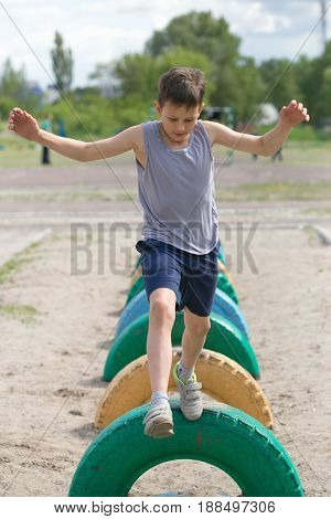 A Teenager In A T-shirt Is Engaged On The Obstacle Course