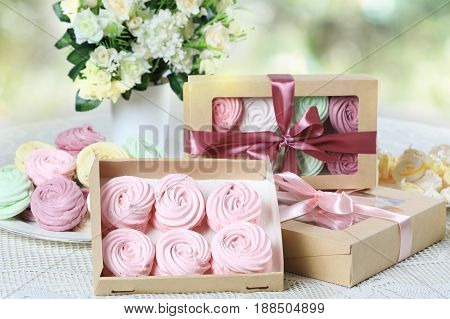 Delicate multicolored homemade zephyr or marshmallows in the box on a white table