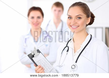 Happy doctor woman with medical staff at the hospital.