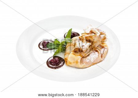 Delicious pancake with cherry and chocolate on plate isolated on White Background. Fresh Homemade Crepes with mint