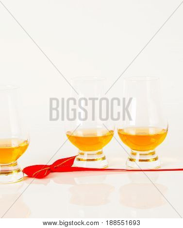 Set Of Single Malt Tasting Glasses, Single Malt Whisky In A Glasses, White Background, Red Bow