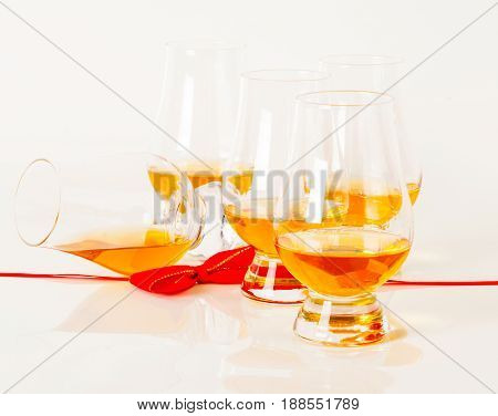 Set Of Single Malt Tasting Glasses, Single Malt Whisky In A Glasses, White Background, Red Bow