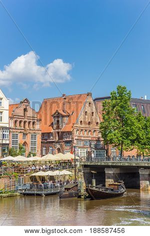 LUNEBURG, GERMANY - MAY 21, 2017: People enjoying the sun in the historic harbor of Luneburg, Germany