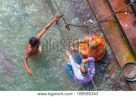 Haridwar, India - March 11, 2017: Unidentified People Bathing And Taking Ablutions In The Ganges Riv