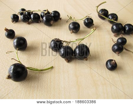 Black currants on wooden board from garden