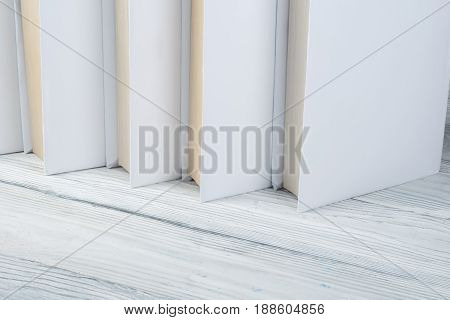 Open black and Whitel books on wooden table, black board background. Back to school. Education business concept