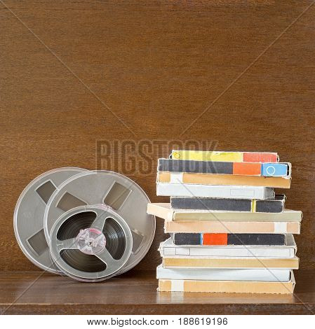 Vintage magnetic audio tapes, reel to reel type, paper box on the grunge wooden shelf