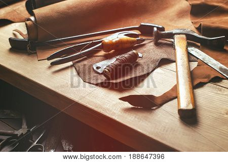 Cobbler Tools In Workshop On The Wooden Table . Top View.