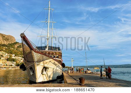 People At Big Ship At Harbor In Omis
