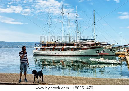 Man With Dog At Harbor In Adriatic Sea In Omis