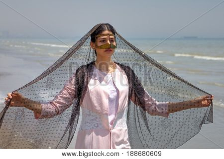 Young muslim woman wears gold mask Hormozgan province southern Iran.