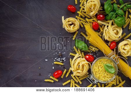 Ingredients For The Preparation Of Italian Pasta - Spaghetti, Fusilli, Fettuccine, Basil, Cherry Tom