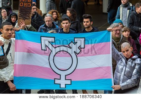 HBTQ flag and protesters.
Stockholm, Sweden - January 21 2017: Close up image of a HBTQ flag and protesters. Multi ethnic group of people holding an HBTQ flag at public event at a public square to make a statement.