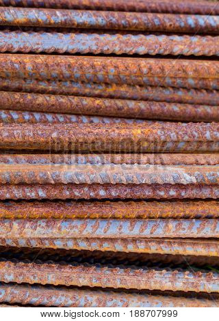 A vertical format closeup shows rusty reinforcing rods.