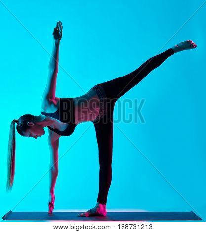 one caucasian woman exercising Ardha Chandrasana  half moon pose yoga exercices  in silhouette studio isolated on blue background