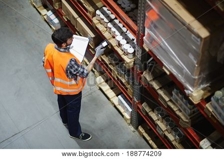 Logistics dispatcher scanning barcodes on packs with goods
