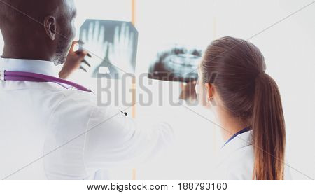 Doctors analyzing an x-ray in a meting