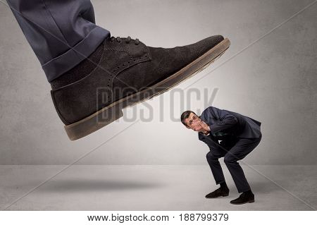 Young businessman illustrated inconsiderable by being trampled