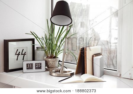 Creative workplace on windowsill in modern room