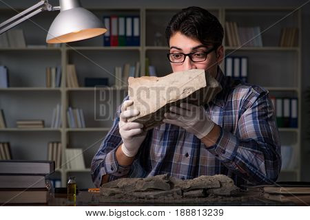 Archeologist working late night in office