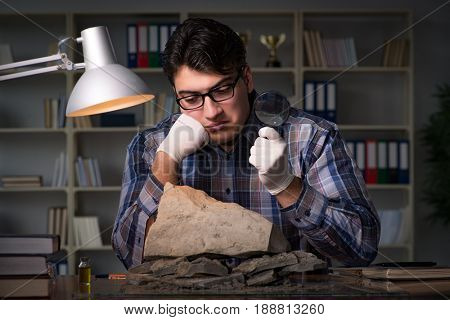 Archeologist working late night in office