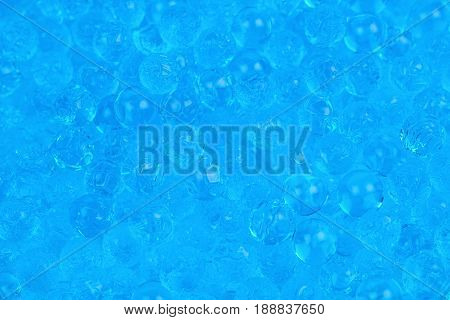 Surface coated with the multiple blue soil water beads as an abstract background composition