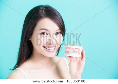 woman with bace tooth model on the green background