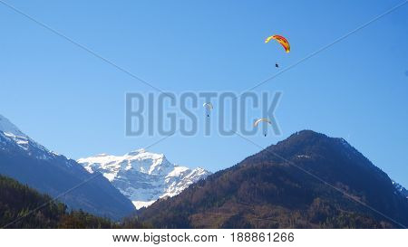 Paragliding with snow mountain and blue sky background