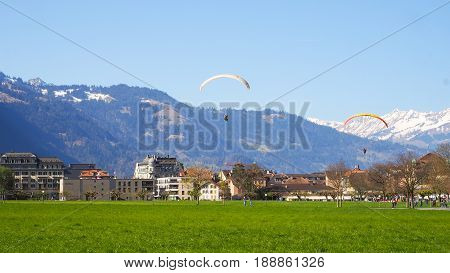 Paragliding with snow mountain and blue sky background