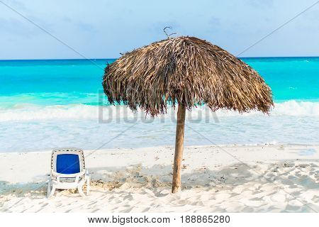 Beautiful tropical beach and Caribbean sea with sunbeds