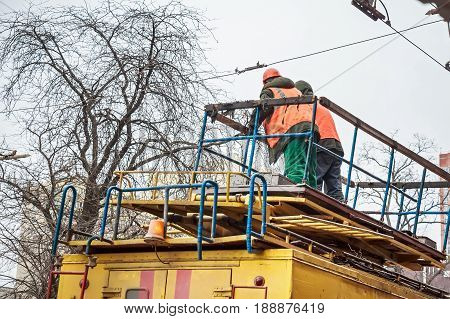 Close up man in uniform standing on top of yellow Russian ectrical emergency service truck