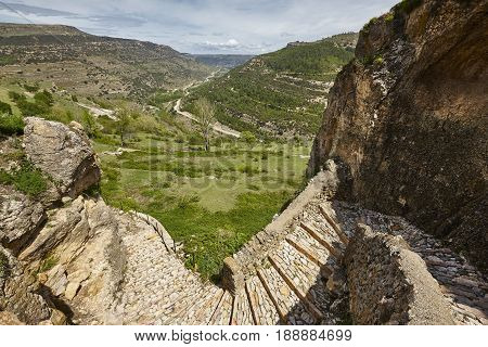 Stone wall walk and green landscape in Cantavieja Teruel. Spain.
