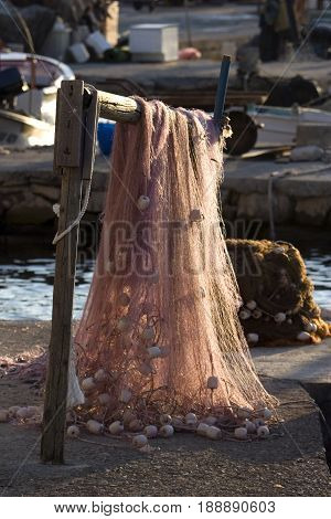 Drying fishing net on wooden beam in village Maslinica on island Solta in Croatia