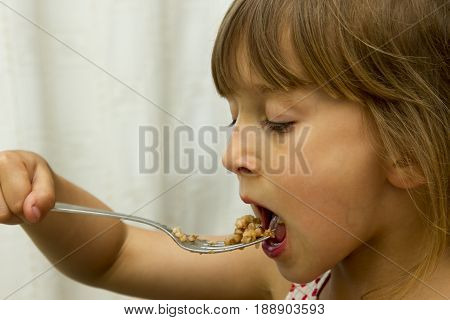 Adorable baby girl eating porridge healthy eating for a child people
