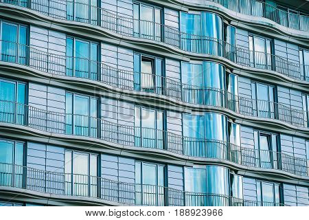 Modern glass building with railing of an hotel.