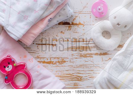 Baby shower concept - child essencials on wood background, copy space