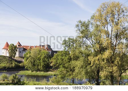 Latvija.Bauskas castle in the distance behind the trees
