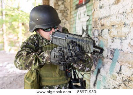 A Soldier With A Gun Assaults The Building. Military Actions And Assault Of Buildings