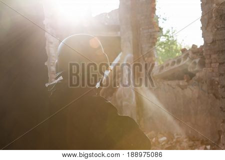 Silhouette Of A Soldier In A Helmet In The Back Light. Military Actions And Assault Of Buildings