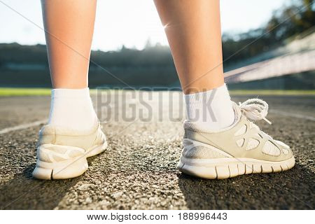 Legs Of Girl In White Sneakers