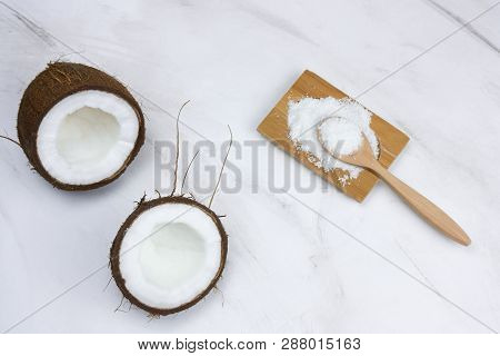 Flat Lay Coconut And Cocnut Flakes  On A  Marble Table