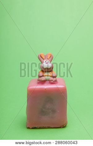 Easter Rabbit Sitting On A Austrian Easter Cake Called Punschkrapfen.