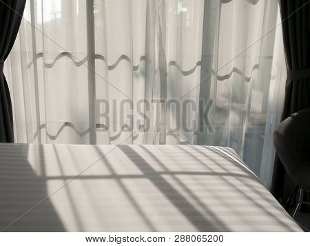 The Sunlight Shone Through The White Curtain In The Bedroom Causing The Shadow Of The Window On The 