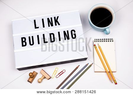 Link Building. Text In Lightbox. White Desk With Stationery